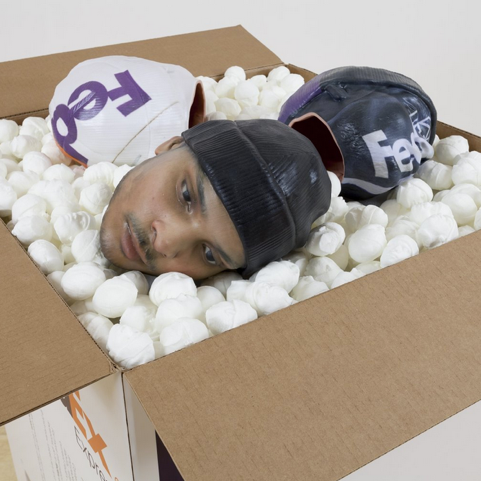 Josh Kline, Packing for Peanuts (Fedex Worker's Head with Knit Cap), 2014